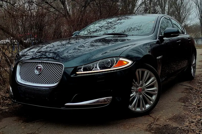 Dark green Jaguar luxury saloon parked outdoors