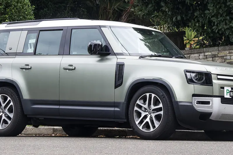 Silver Land Rover Defender SUV, side view