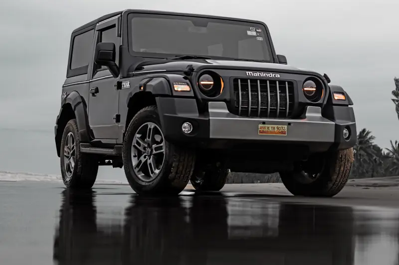 Black Mahindra Thar off-roader on a wet road