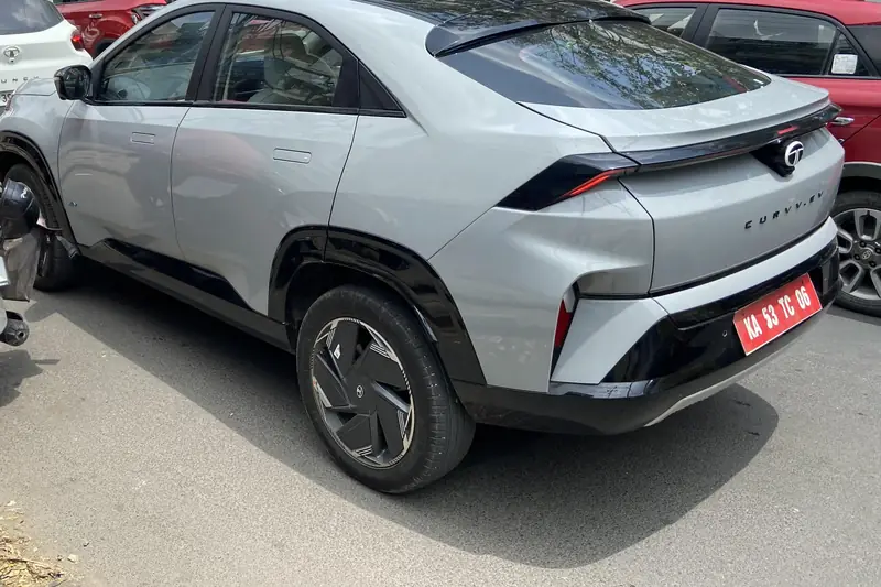 Silver Tata Curvv coupe SUV, rear three-quarter view